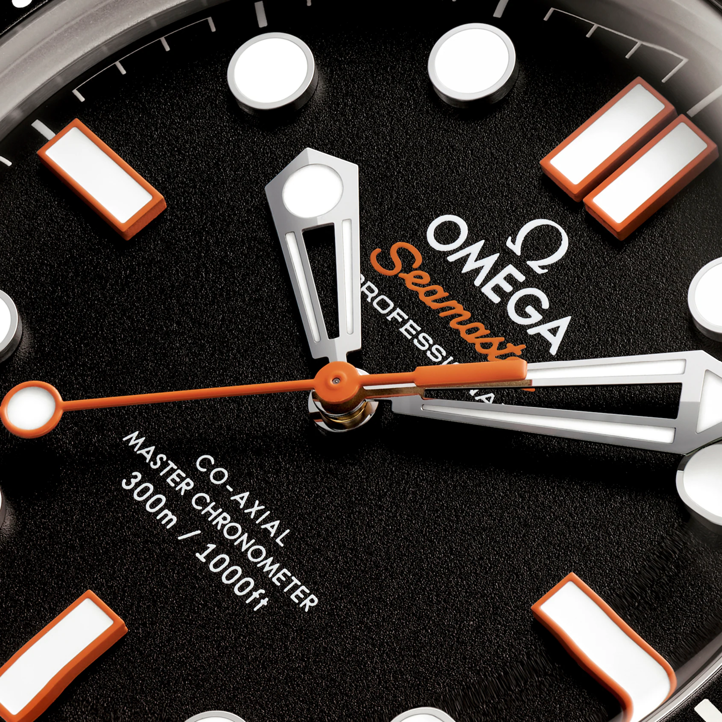 Close-up of an Omega Seamaster watch face with black background and orange accents.