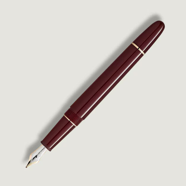 Maroon fountain pen on a light gray background