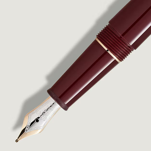 Maroon fountain pen on a light gray background