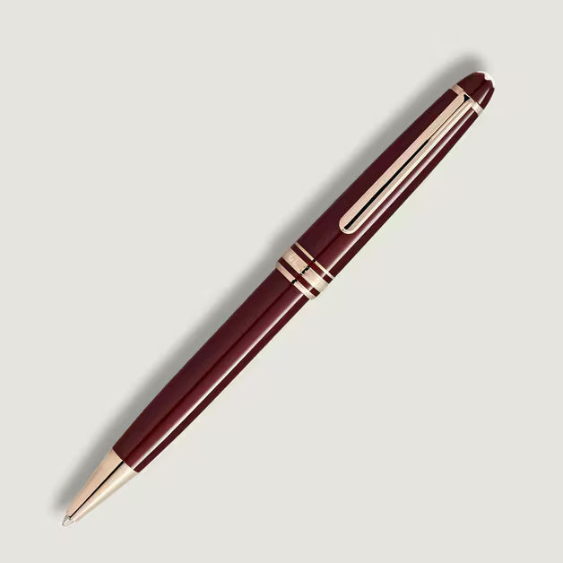 Maroon pen with gold accents on a light gray background