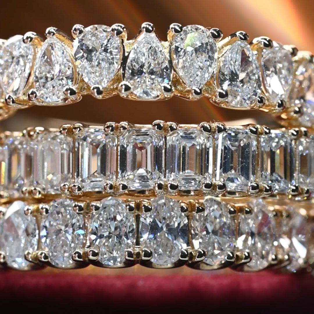 Close-up of a diamond ring with various cut diamonds on a blurred background