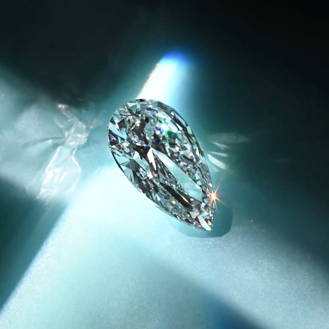 Teardrop-shaped diamond on a dark background