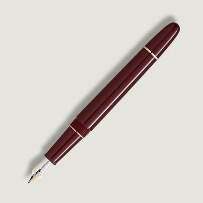 Maroon fountain pen on a light gray background