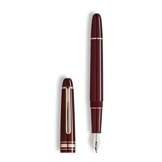 Maroon fountain pen with silver accents on a white background